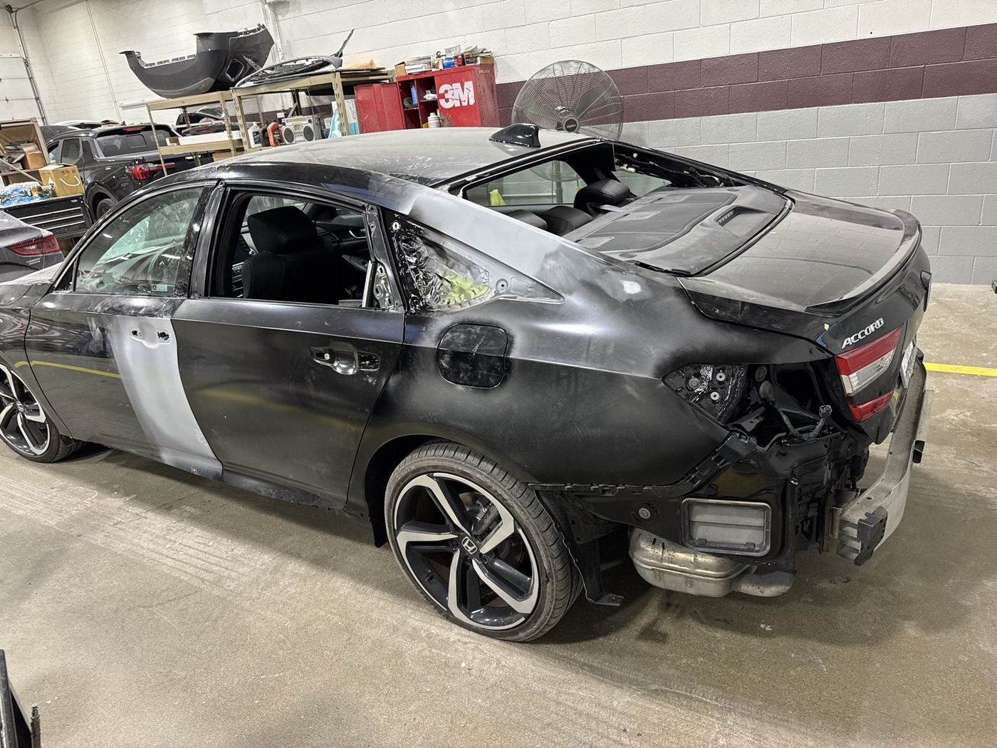 Honda Accord disassembled with body filler applied and panels masked off for paint during collision repair at Bob Rohrman Collision Repair Center in Lafayette, Indiana