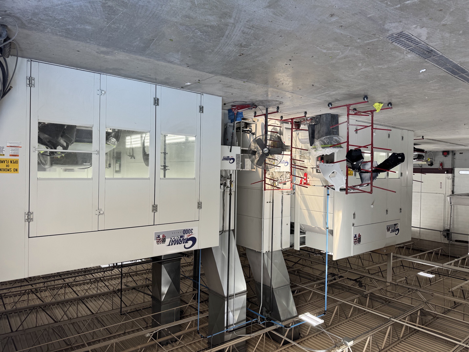Downdraft paint booths at the Bob Rohrman Collision Lafayette facility, used for factory-spec basecoat and clearcoat application