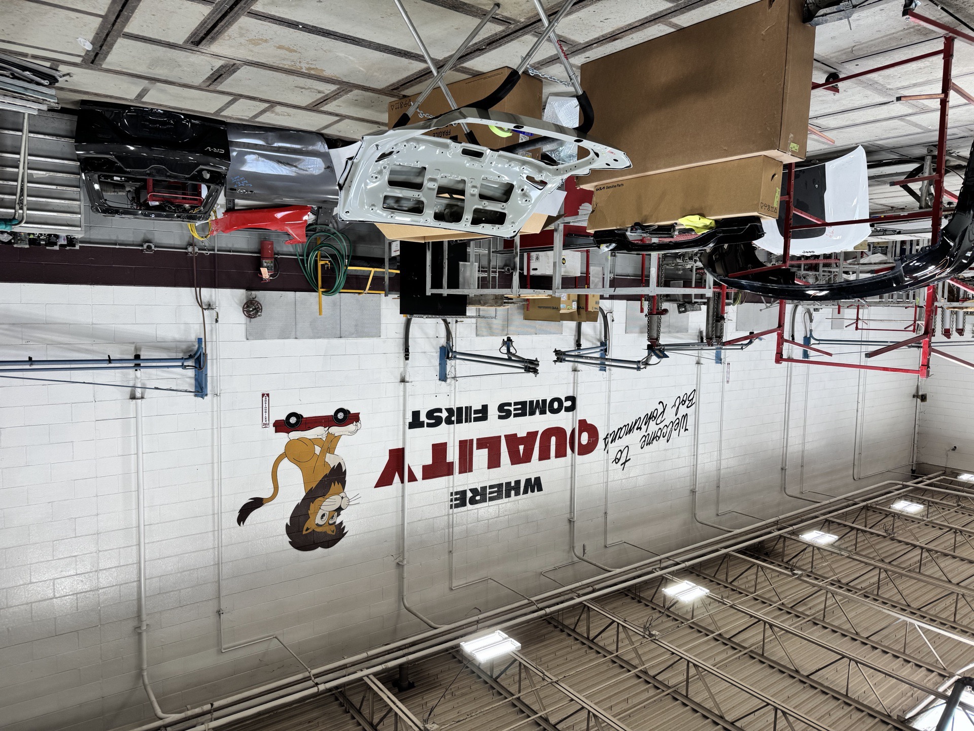 Interior repair bays at Bob Rohrman Collision in Lafayette IN, showing vehicles in active I-CAR Gold Class certified collision repair