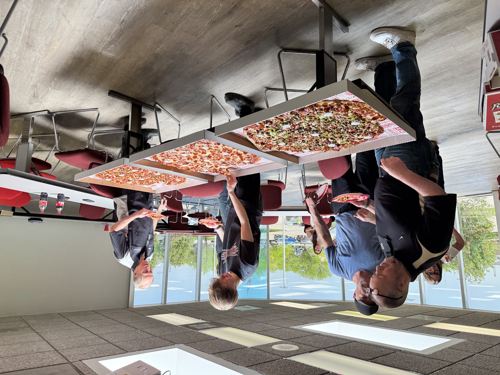 Bob Rohrman Collision Repair Center technician team celebrating a milestone with a pizza lunch at the Lafayette IN shop